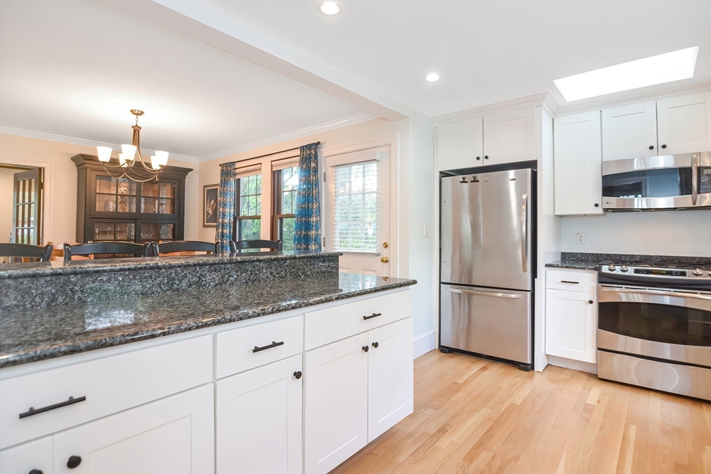 15 Evans Road Needham, MA 02492 - Photo 8 of 30 a kitchen with stainless steel appliances granite countertop a refrigerator a stove a sink and a wooden floor