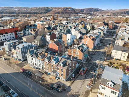an aerial view of residential houses with city view