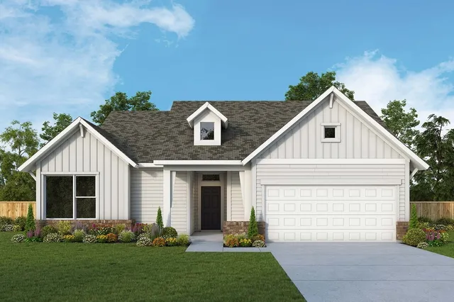 a front view of a house with a garden and plants