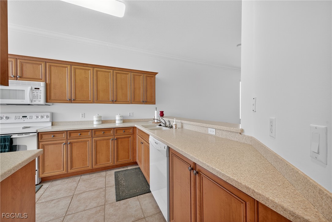 8251 Pathfinder Loop, Unit 621 Fort Myers, FL 33919 - Photo 11 of 32 a kitchen with a sink and cabinets