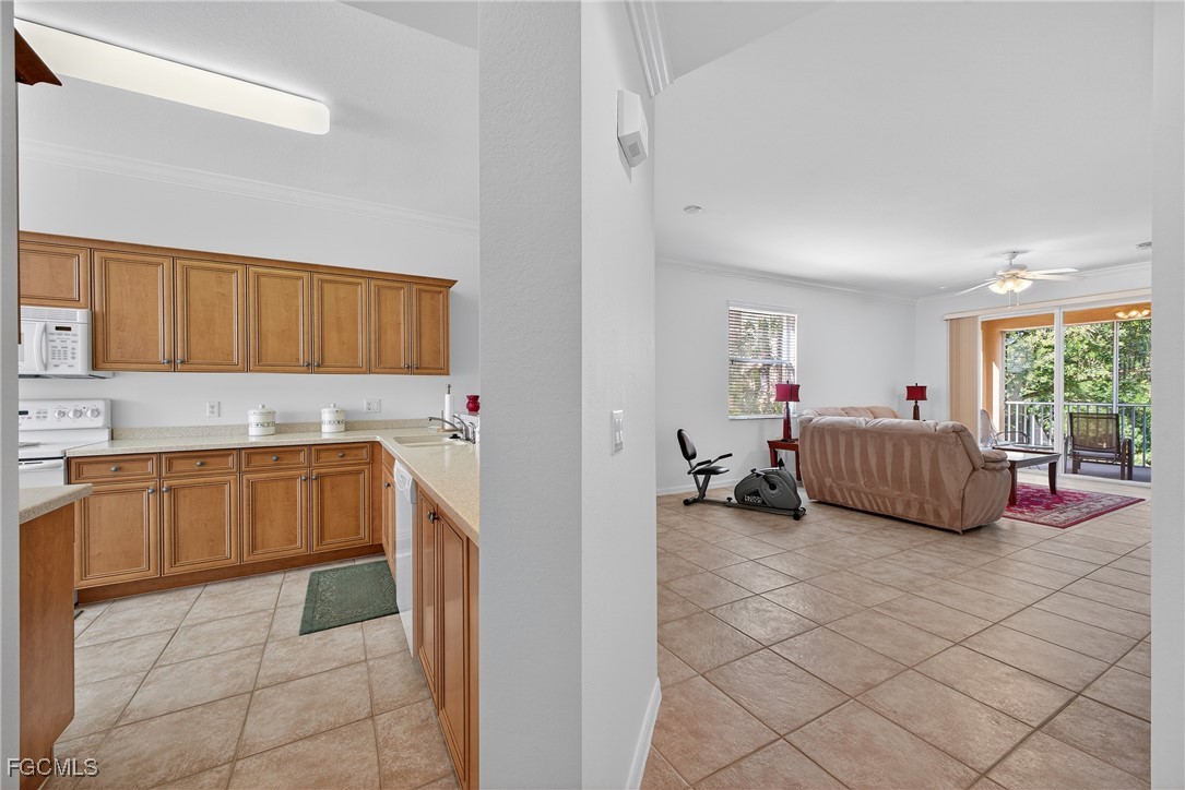 8251 Pathfinder Loop, Unit 621 Fort Myers, FL 33919 - Photo 13 of 32 a kitchen with a sink and cabinets