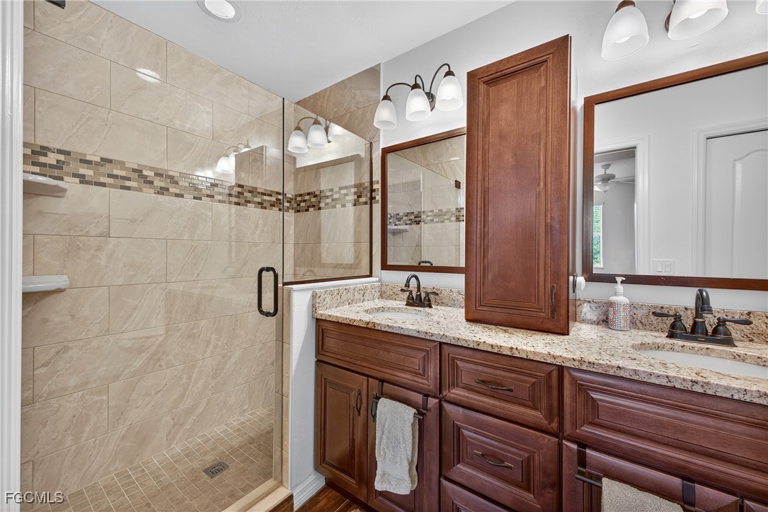 8251 Pathfinder Loop, Unit 621 Fort Myers, FL 33919 - Photo 16 of 32 a bathroom with a granite countertop sink mirror and double