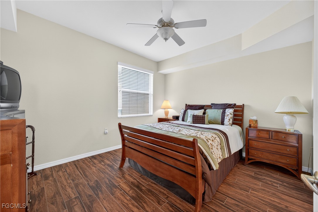 8251 Pathfinder Loop, Unit 621 Fort Myers, FL 33919 - Photo 18 of 32 a bedroom with a bed and a chandelier