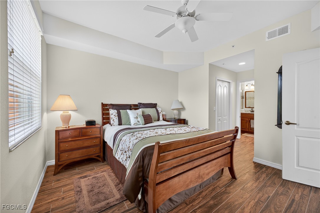 8251 Pathfinder Loop, Unit 621 Fort Myers, FL 33919 - Photo 19 of 32 a bedroom with a bed and a chandelier