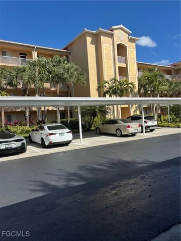 a car parked beside a road next to a building
