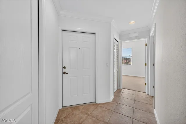 a living room with lots of furniture a chandelier fan and a large window