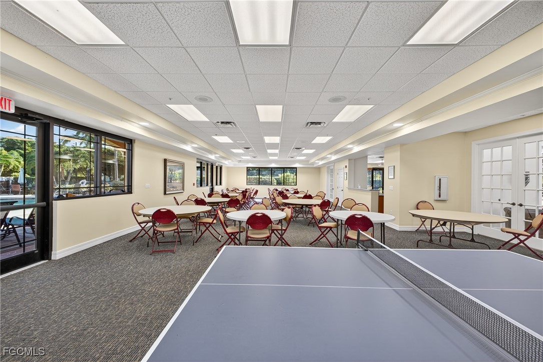 8251 Pathfinder Loop, Unit 621 Fort Myers, FL 33919 - Photo 30 of 32 a living room with lots of furniture a chandelier fan and a large window