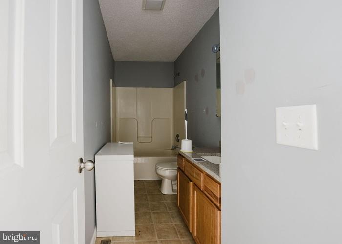 207 Broad Street Hurlock, MD 21643 - Photo 15 of 19 a bathroom with a sink a toilet and a mirror