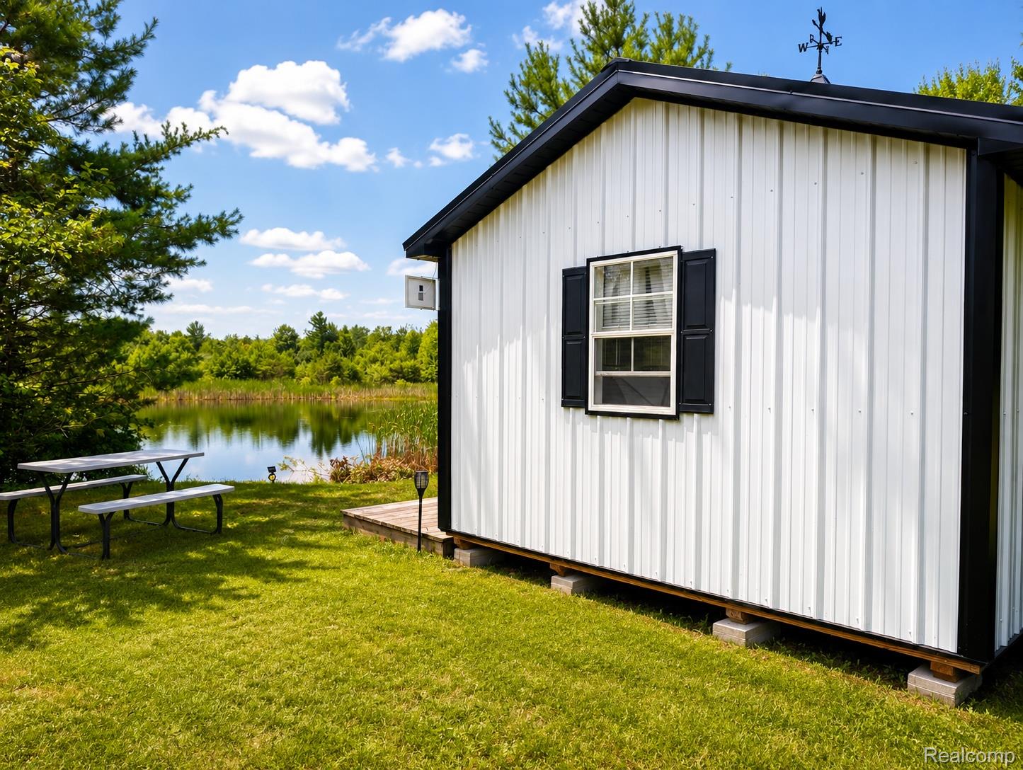 643 North Hockaday Road Gladwin, MI 48624 - Photo 14 of 24 Enhanced_Cabin_Exterior_Lakeside.jpg