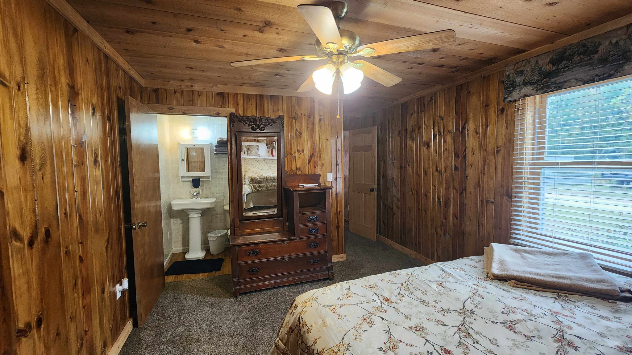 348 Bill Hunter Road Celina, TN 38551 - Photo 13 of 50 a bedroom with a bed and a chandelier