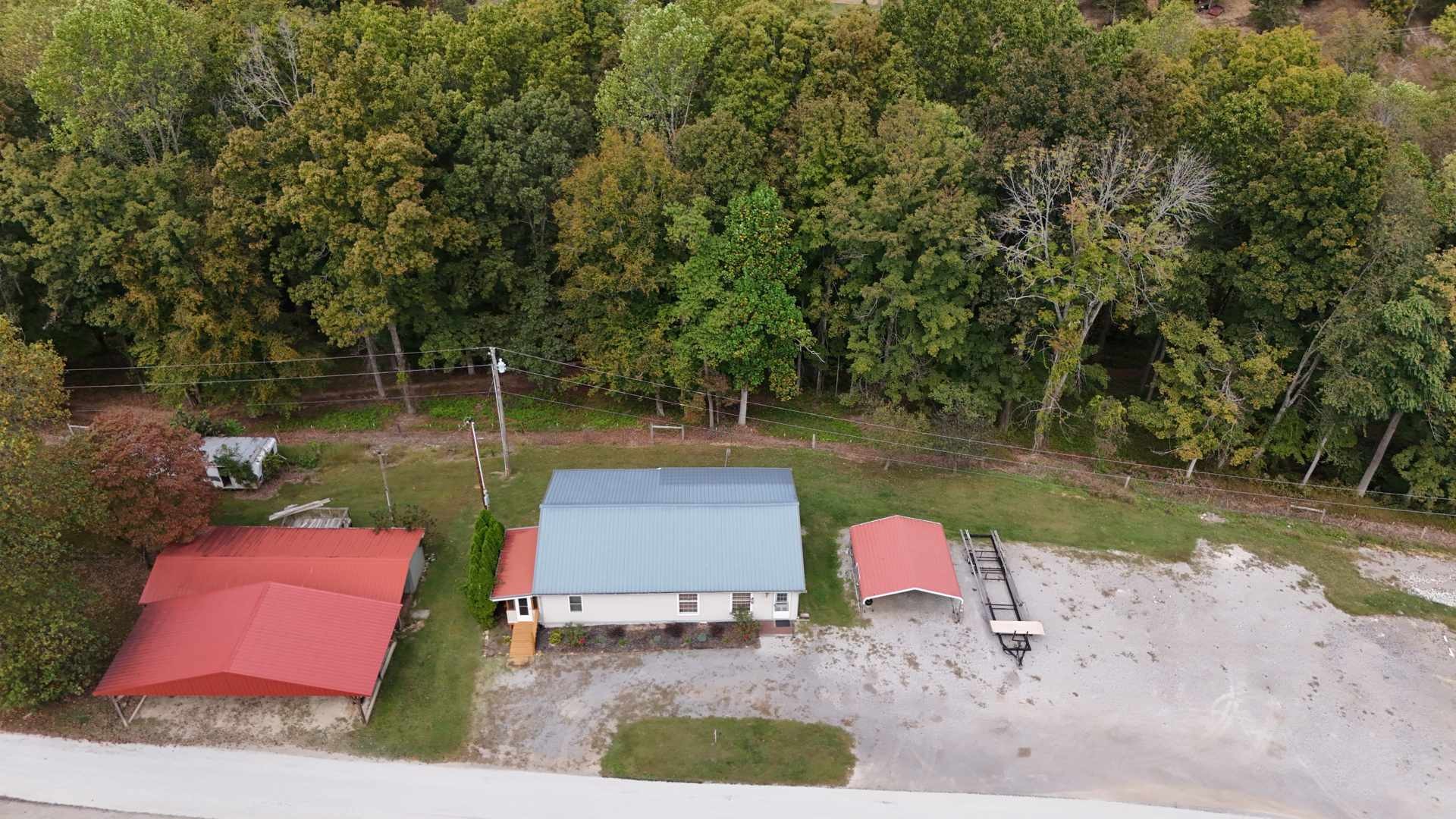 348 Bill Hunter Road Celina, TN 38551 - Photo 36 of 50 a lake view with a bench and trees