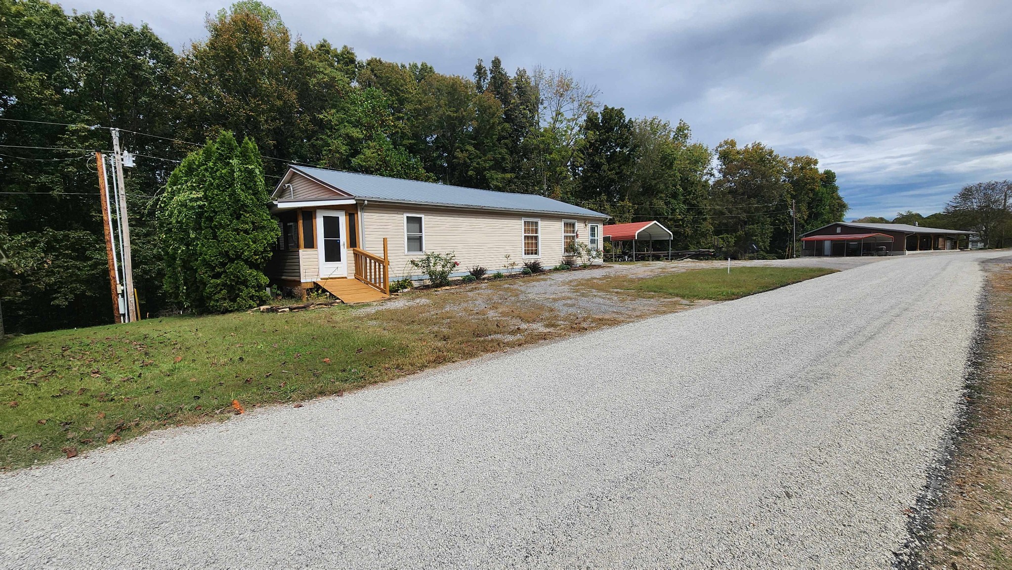 348 Bill Hunter Road Celina, TN 38551 - Photo 44 of 50 a view of a house with backyard and trees