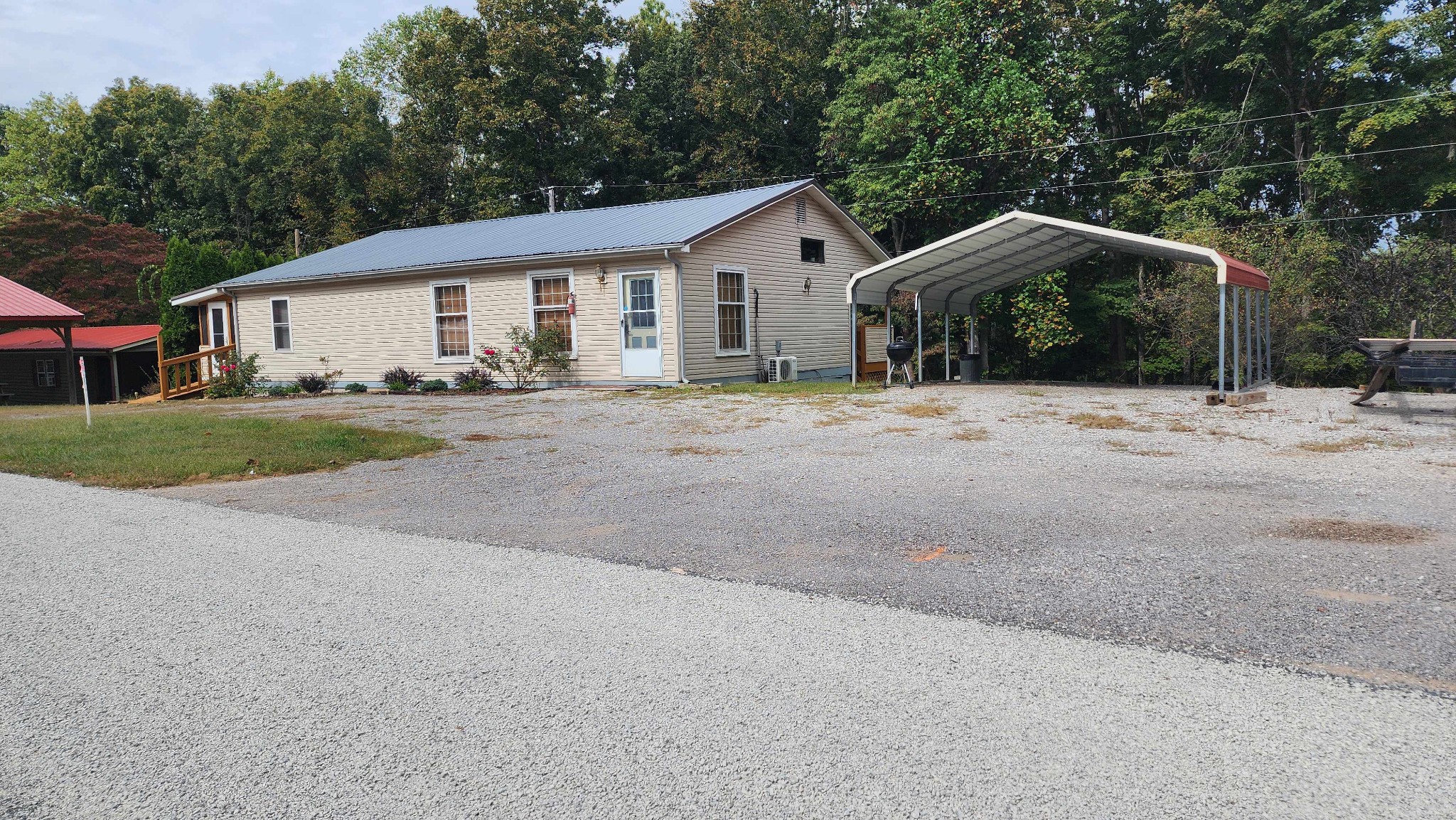 348 Bill Hunter Road Celina, TN 38551 - Photo 45 of 50 a view of a house with a yard and large trees
