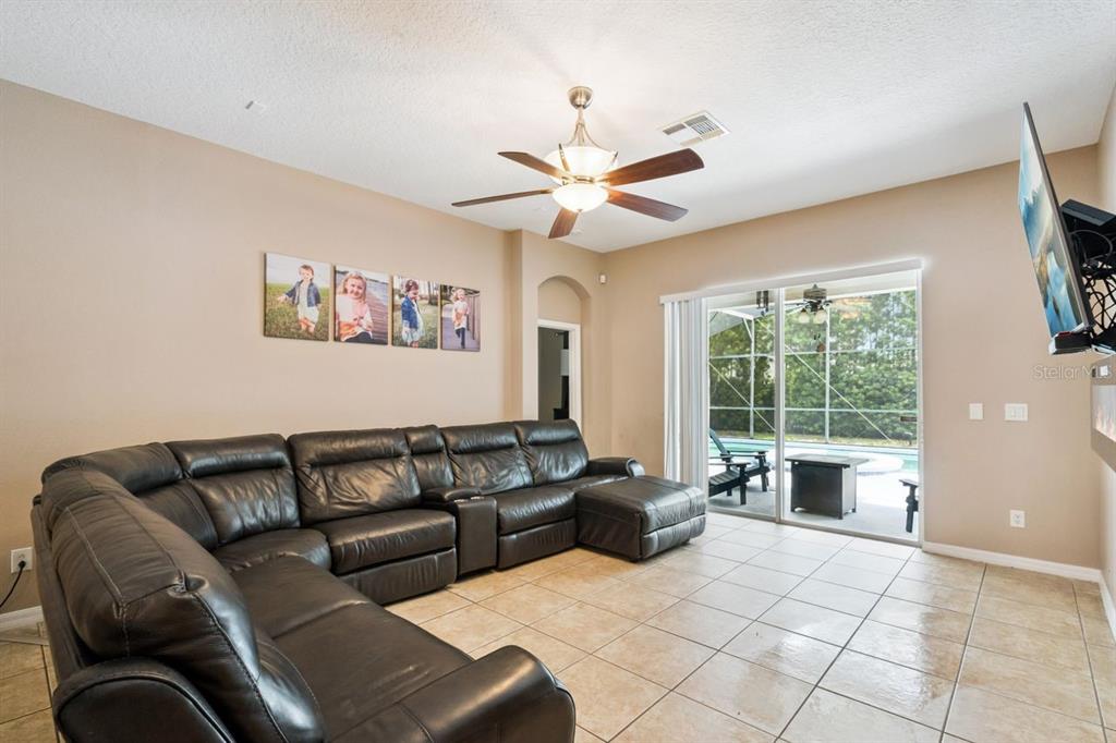 8484 Dover View Lane Orlando, FL 32829 - Photo 9 of 41 a living room with furniture and a large window