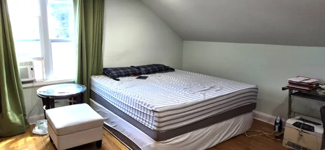 a bedroom with furniture and a flat screen tv