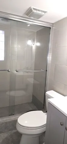 a bathroom with a sink toilet and mirror