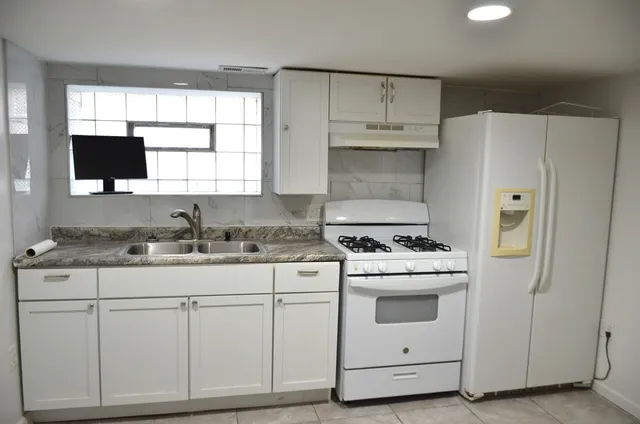 a view of a small space with wooden floor and a window