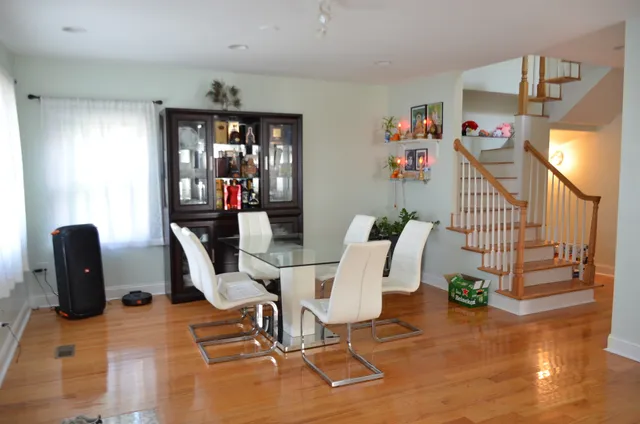 a dining room filled with furniture and wooden floor
