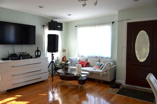 a living room with furniture and a flat screen tv