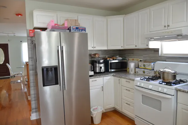 a kitchen with stainless steel appliances a refrigerator sink and cabinets
