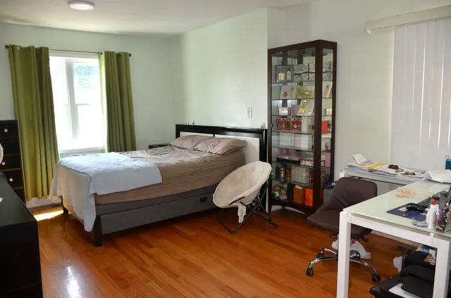 a bedroom with a bed and a window