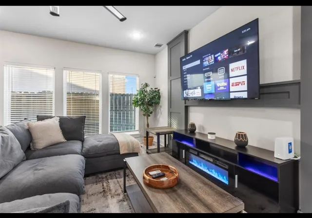 a living room with furniture fireplace and flat screen tv