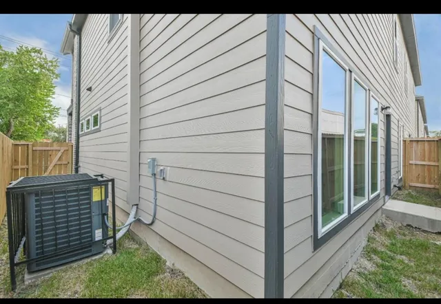 a view of a porch with wooden floor and a fence