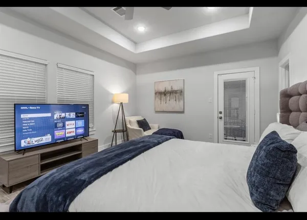 a bedroom with a bed and a flat screen tv