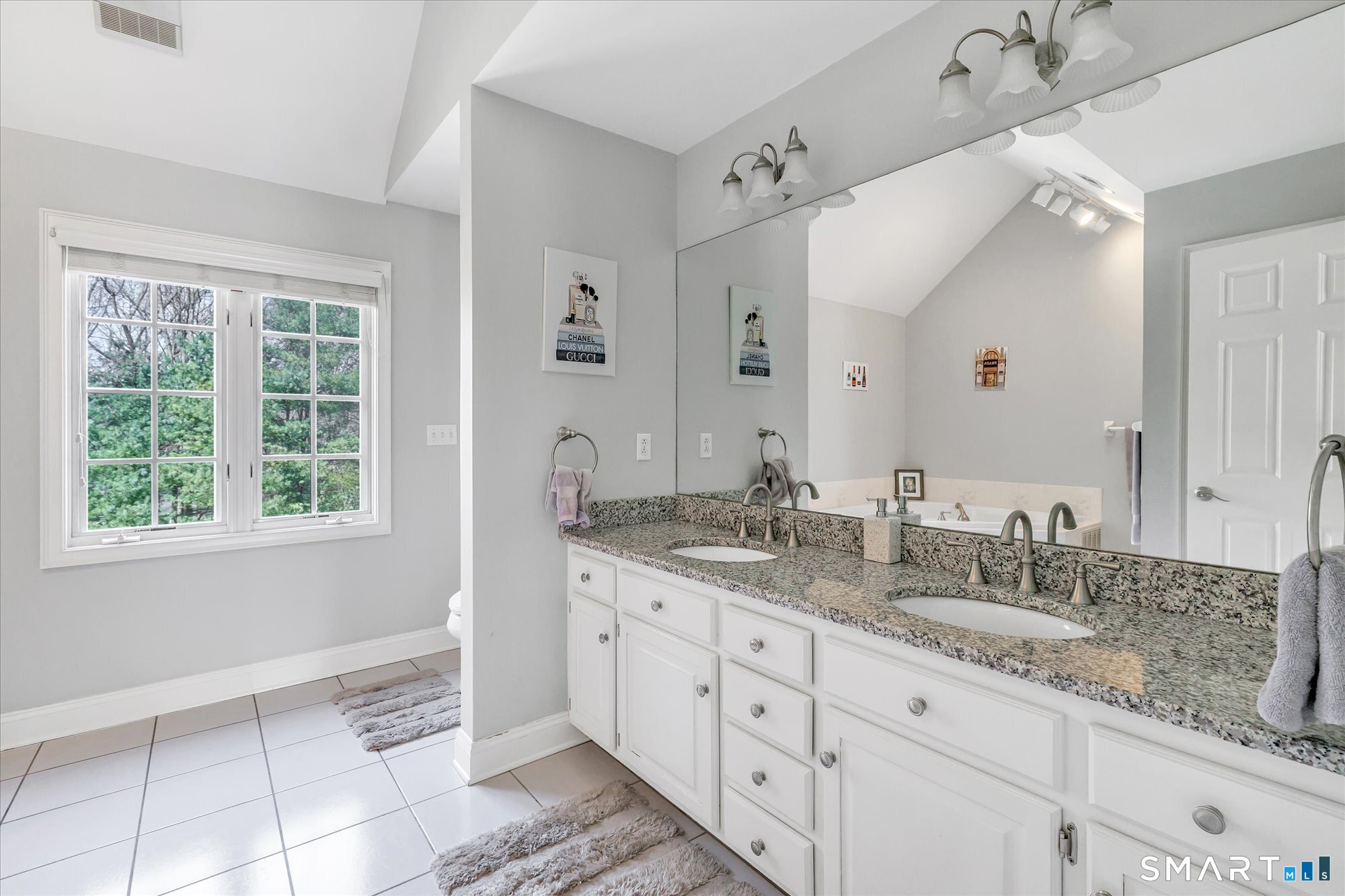 111 Stones Throw Trumbull, CT 06611 - Photo 31 of 47 a spacious bathroom with double sink a mirror a window and a shower