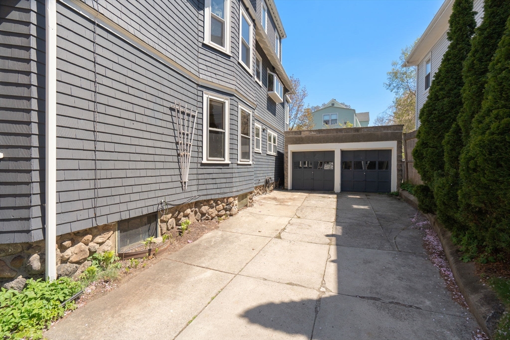 45 Springfield Street, Unit 1 Belmont, MA 02478 - Photo 24 of 27 a pathway of a house with a yard
