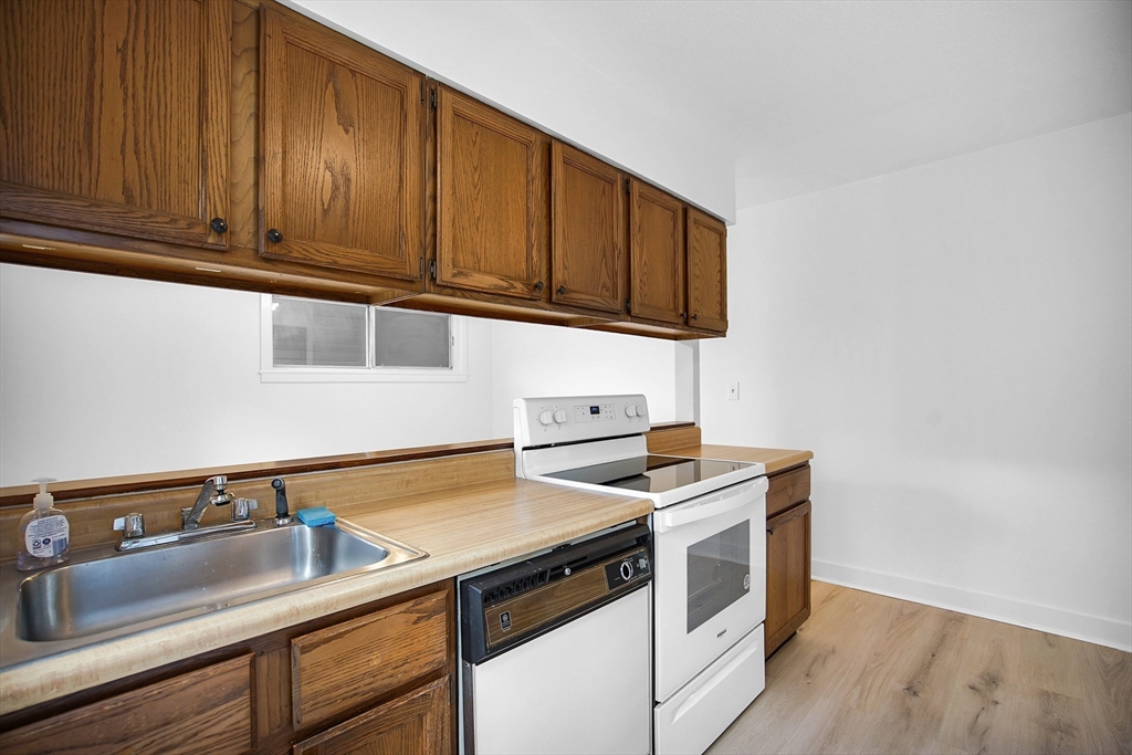 45 Horseshoe Drive, Unit 45 Chicopee, MA 01022 - Photo 11 of 31 a kitchen with granite countertop a sink cabinets and stainless steel appliances