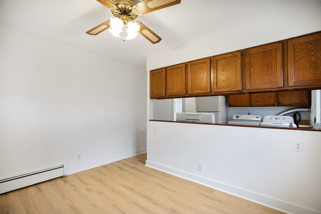 45 Horseshoe Drive, Unit 45 Chicopee, MA 01022 - Photo 13 of 31 a kitchen with kitchen island a sink and wooden cabinets