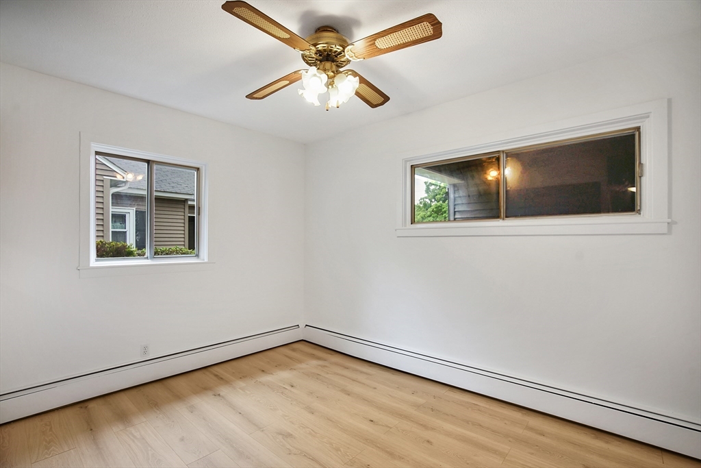 45 Horseshoe Drive, Unit 45 Chicopee, MA 01022 - Photo 14 of 31 an empty room with wooden floor and windows