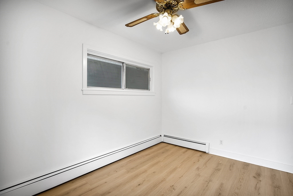 45 Horseshoe Drive, Unit 45 Chicopee, MA 01022 - Photo 15 of 31 an empty room with wooden floor fan and windows