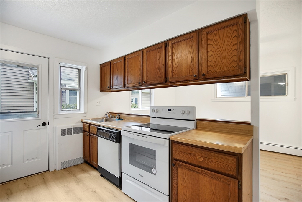 45 Horseshoe Drive, Unit 45 Chicopee, MA 01022 - Photo 2 of 31 a kitchen with a stove and a microwave