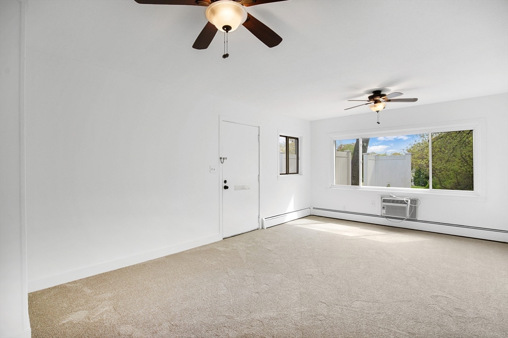 45 Horseshoe Drive, Unit 45 Chicopee, MA 01022 - Photo 6 of 31 an empty room with a ceiling fan and window