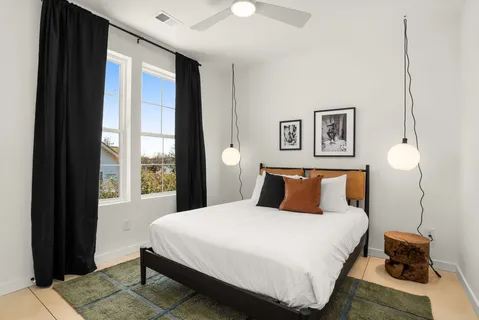 a bedroom with a bed and a window