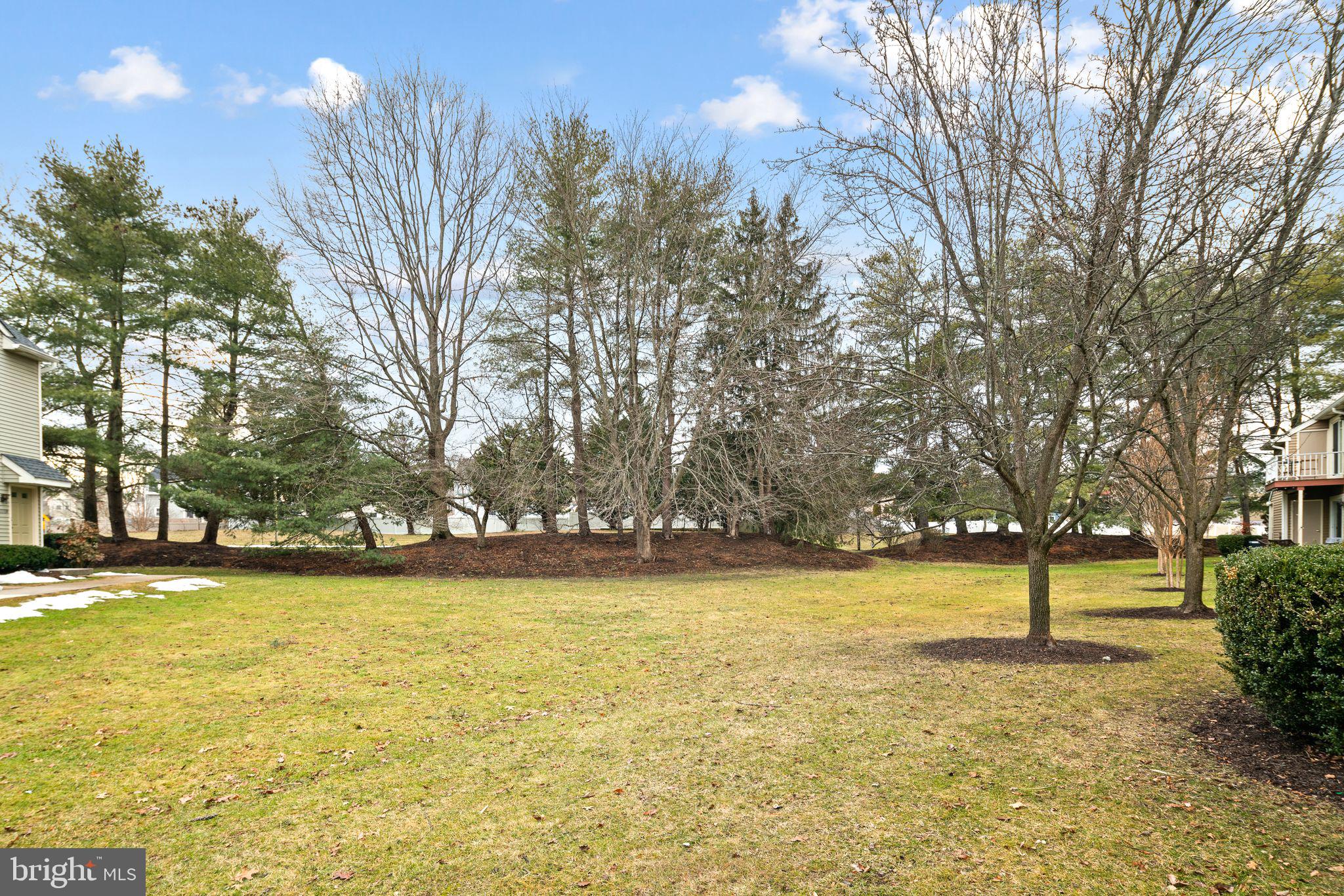 505 A Ralston Drive Mount Laurel, NJ 08054 - Photo 17 of 18 a view of a swimming pool and trees in the background