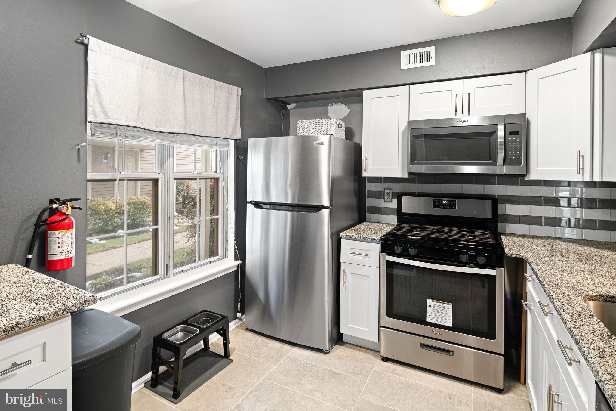 505 A Ralston Drive Mount Laurel, NJ 08054 - Photo 3 of 18 a kitchen with granite countertop a stove and a refrigerator