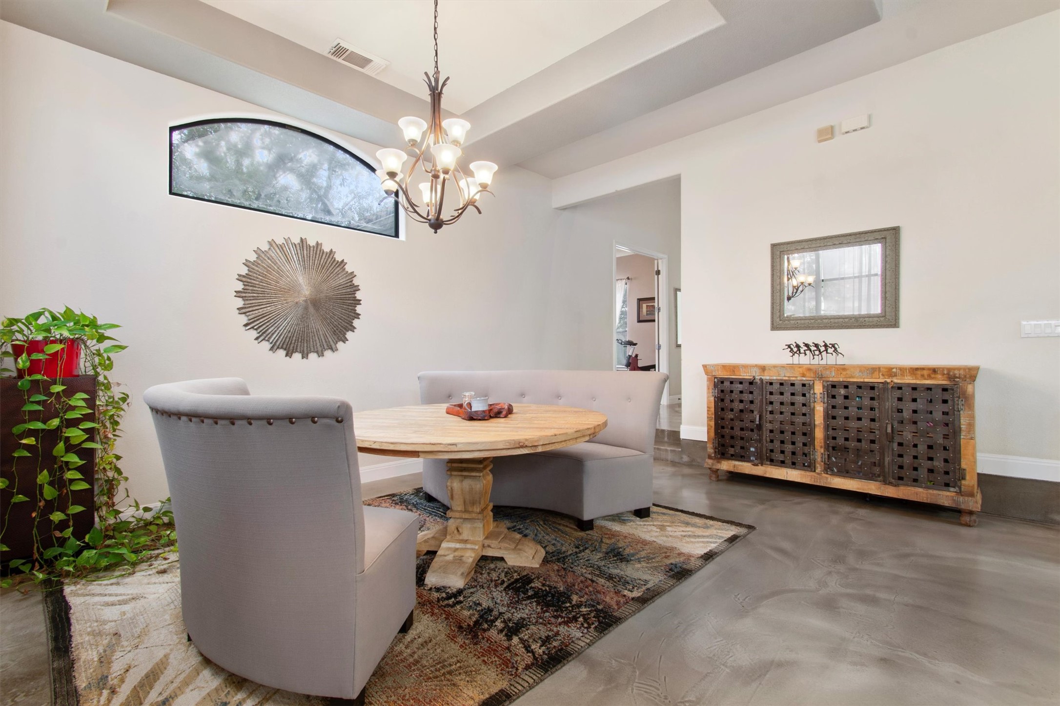 6 Monarch Oaks Lane Austin, TX 78738 - Photo 14 of 40 Dining room featuring finished concrete flooring, a tray ceiling, and a chandelier