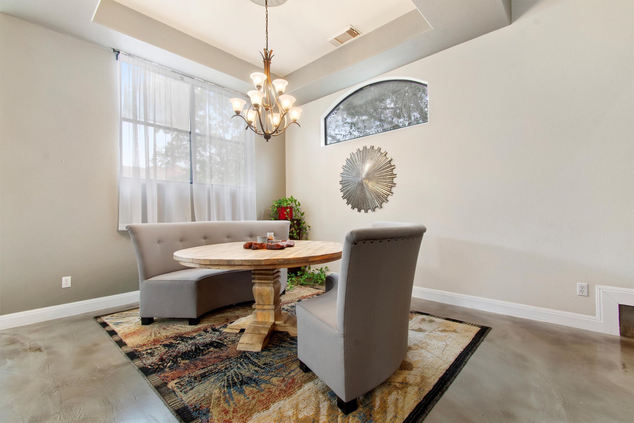 6 Monarch Oaks Lane Austin, TX 78738 - Photo 15 of 40 Dining space with concrete flooring, a tray ceiling, and a chandelier