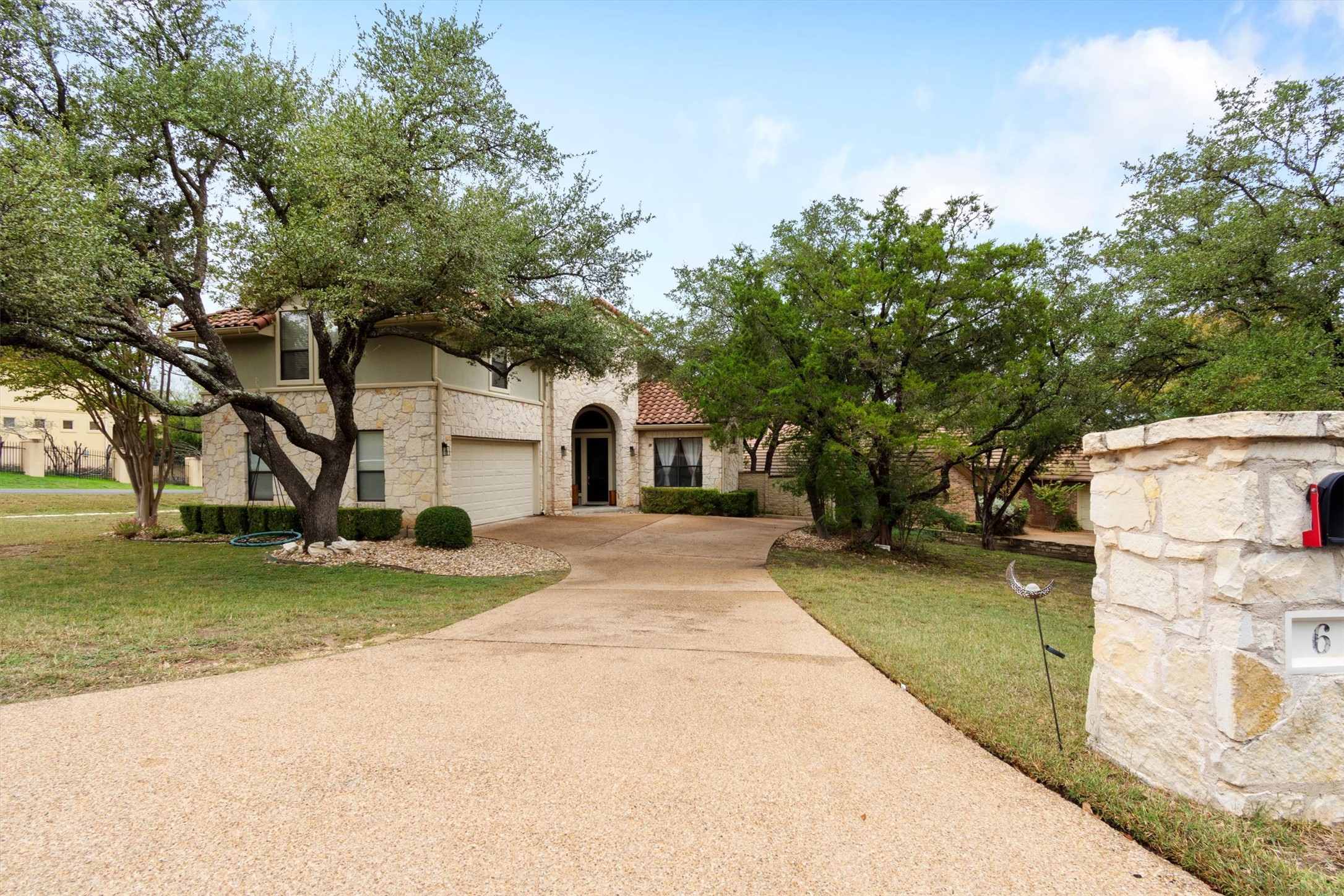 6 Monarch Oaks Lane Austin, TX 78738 - Photo 2 of 40 Mediterranean / spanish house featuring driveway, stone siding, a front yard, and a tile roof