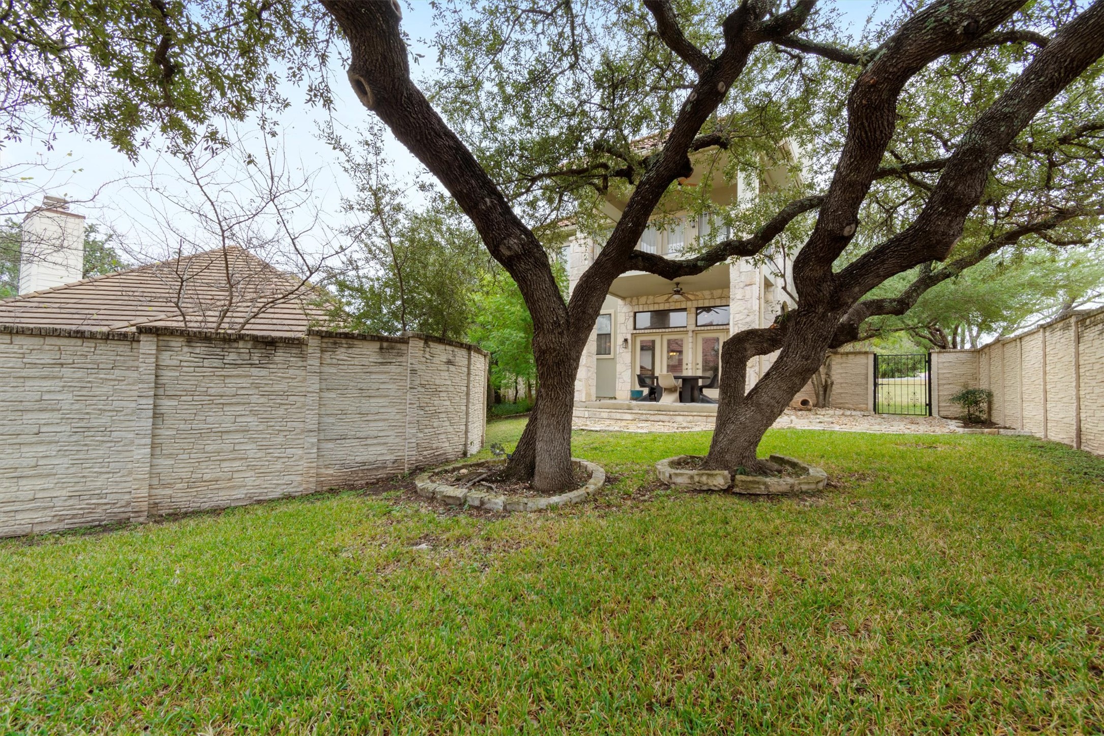 6 Monarch Oaks Lane Austin, TX 78738 - Photo 30 of 40 Fenced backyard with a patio area