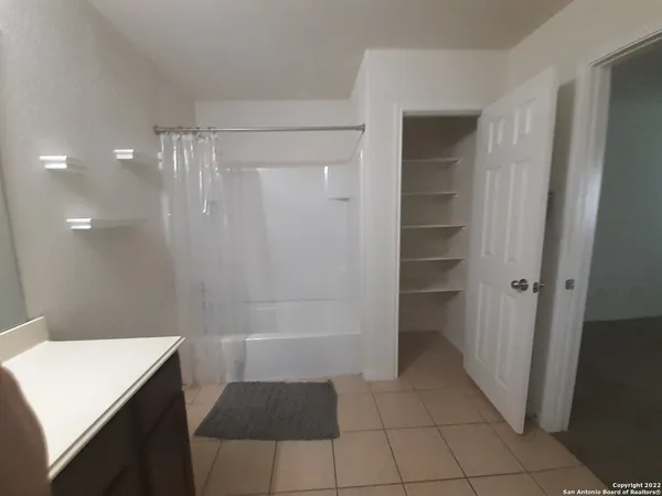 a bathroom with a shower and a sink