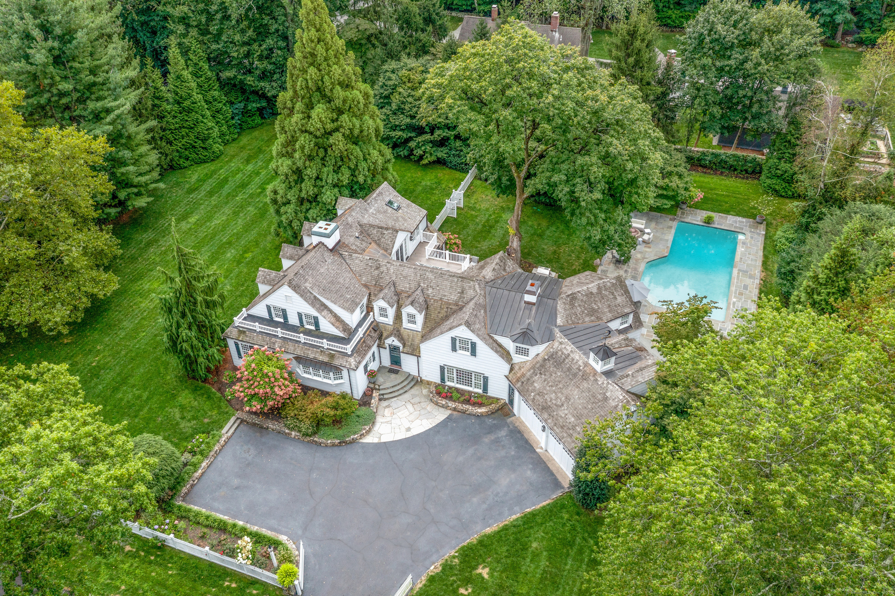 an aerial view of a house with a yard basket ball court and outdoor seating