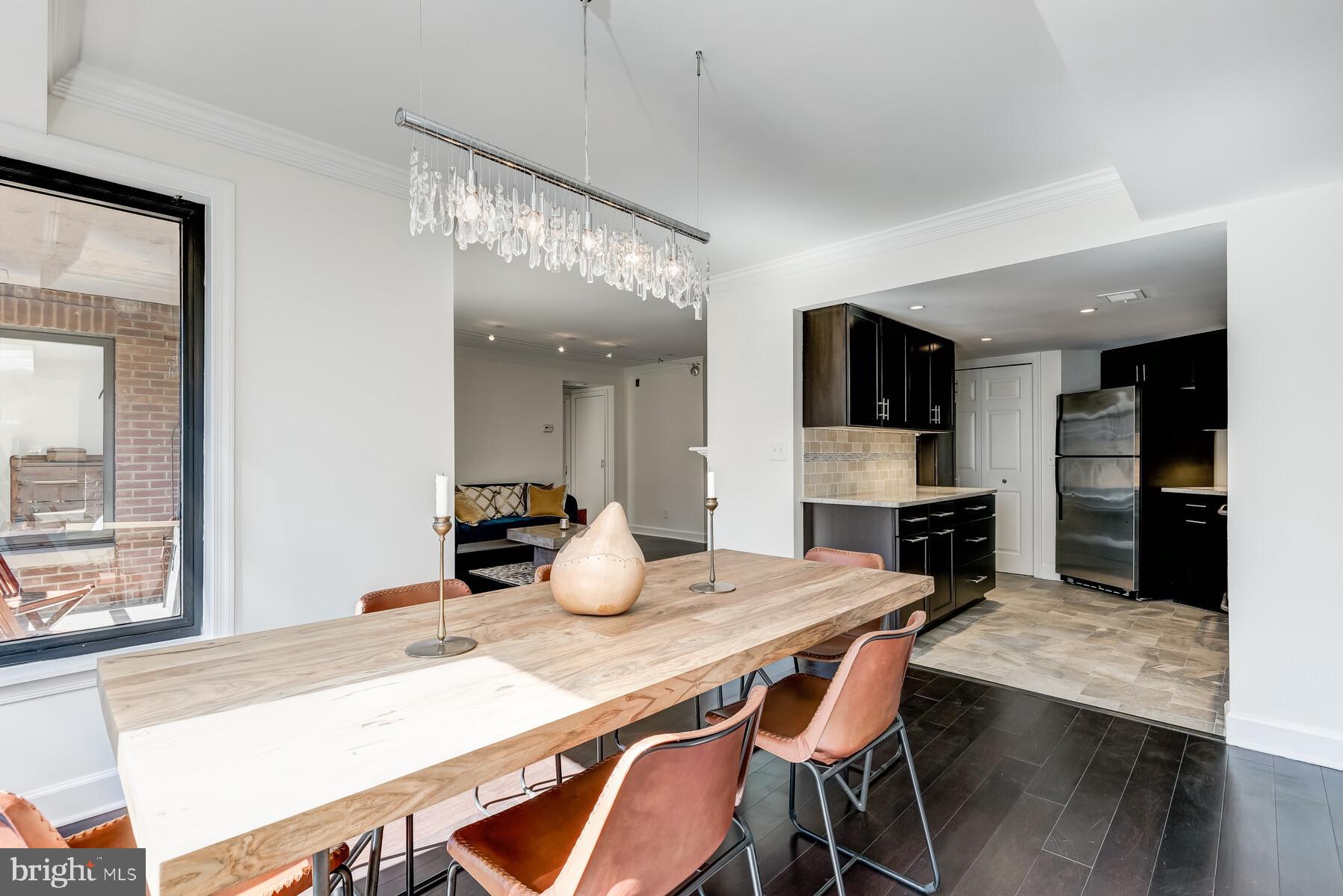 1080 Wisconsin Avenue Northwest, Unit 2001 Washington, DC 20007 - Photo 11 of 30 a kitchen with a table and chairs in it