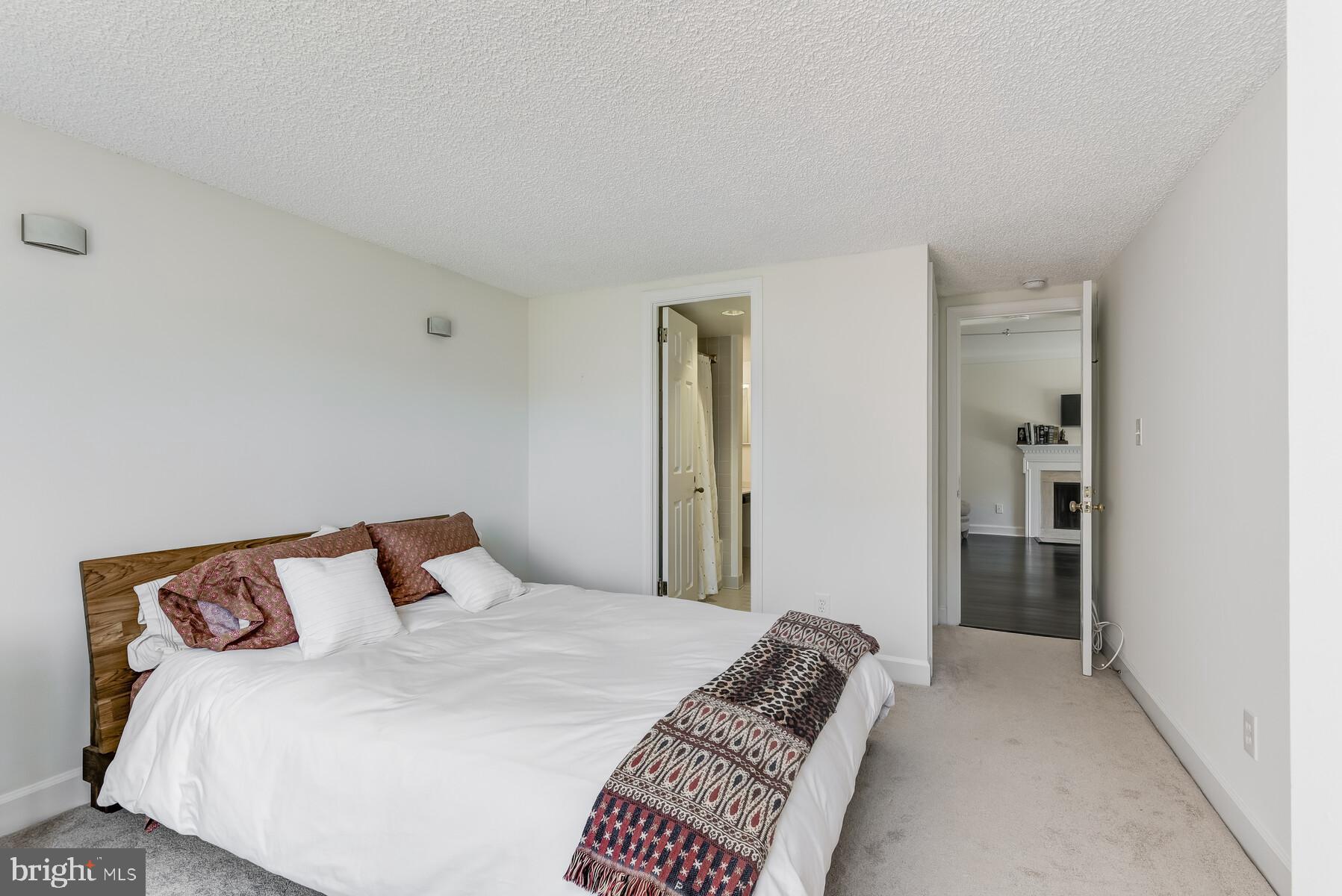 1080 Wisconsin Avenue Northwest, Unit 2001 Washington, DC 20007 - Photo 24 of 30 a bedroom with a bed and closet