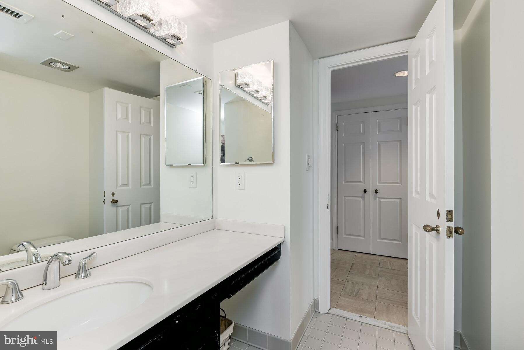 1080 Wisconsin Avenue Northwest, Unit 2001 Washington, DC 20007 - Photo 25 of 30 a bathroom with a sink and a mirror