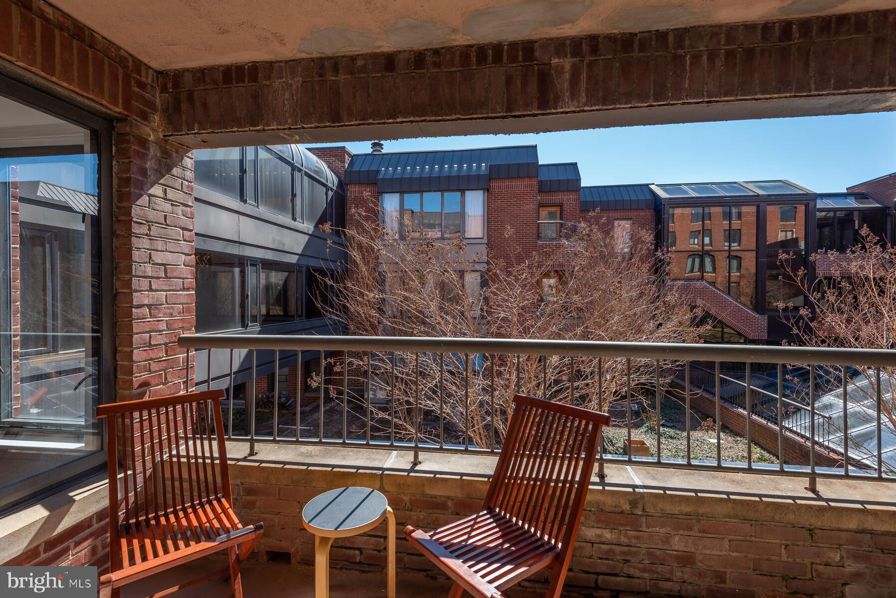 1080 Wisconsin Avenue Northwest, Unit 2001 Washington, DC 20007 - Photo 27 of 30 a balcony with table and chairs