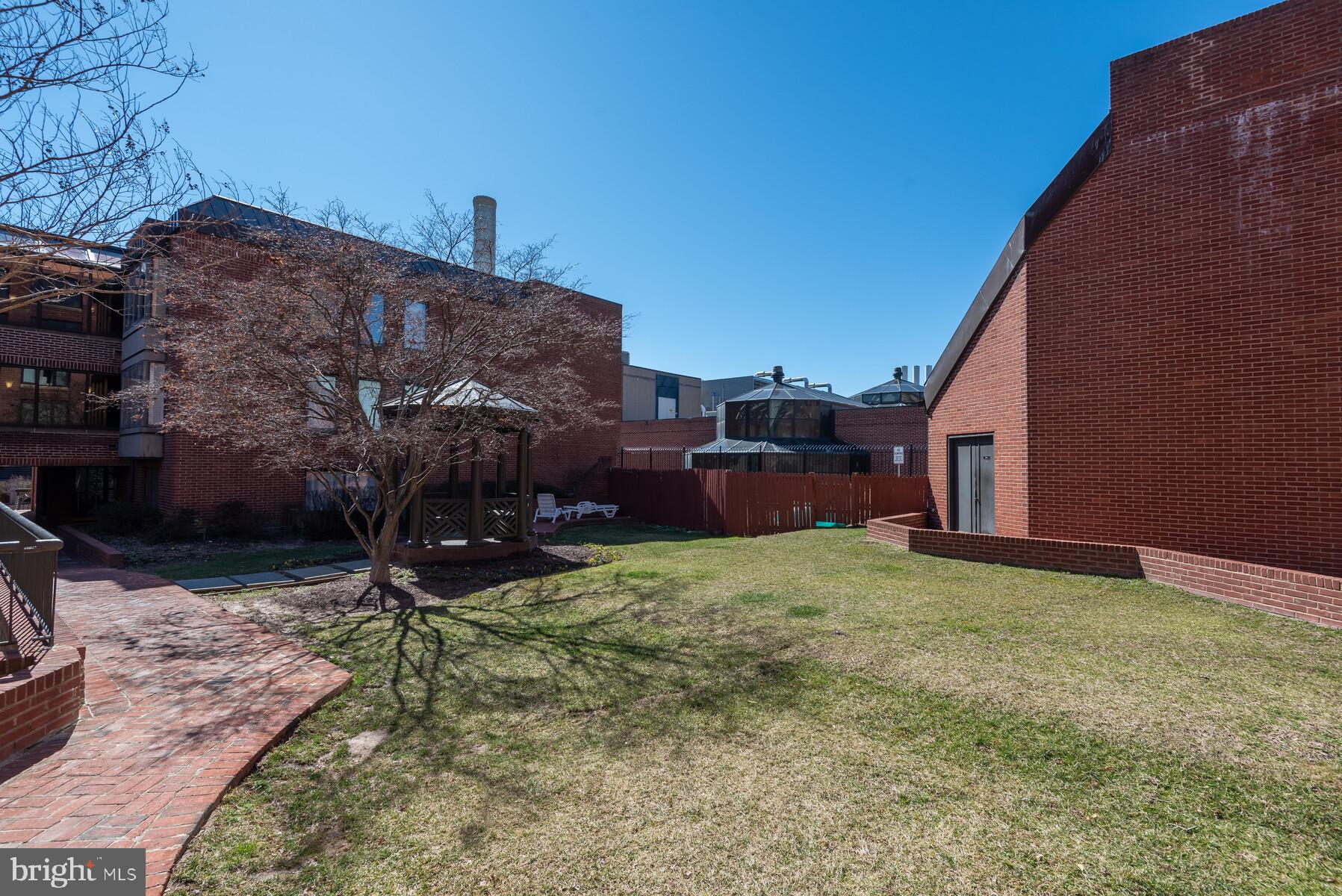 1080 Wisconsin Avenue Northwest, Unit 2001 Washington, DC 20007 - Photo 28 of 30 a backyard of a house with barbeque oven